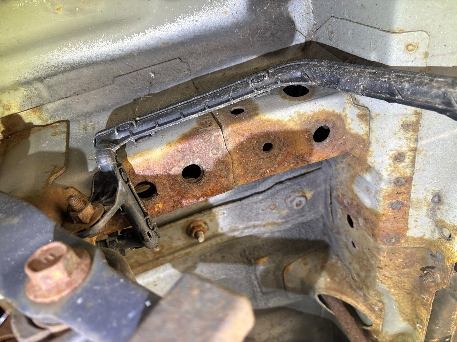 Inspector photo — rusted bracket panel