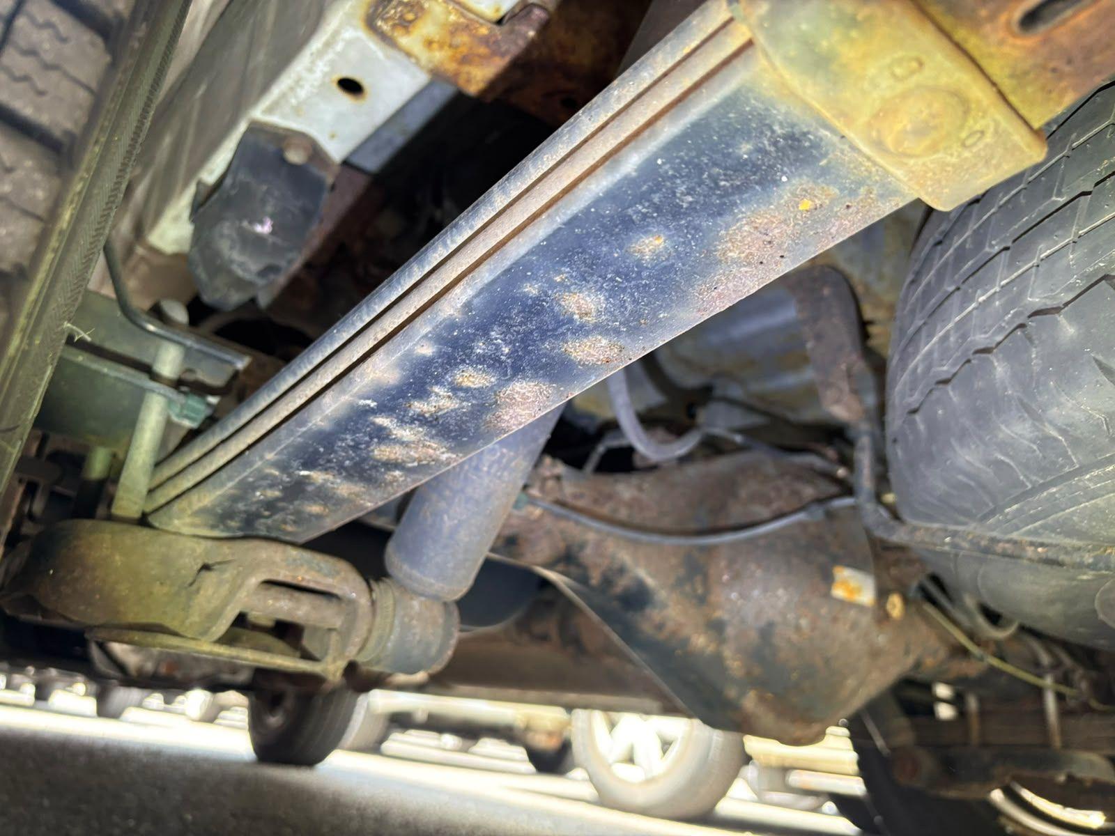 Inspector photo — leaf spring and frame rust